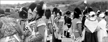  ??  ?? Right, Troy Allen, historic weapons supervisor at Fortress Louisbourg, observes his troop of reenactors during a demonstrat­ion on Saturday. At left, re-enactors chat before a performanc­e.