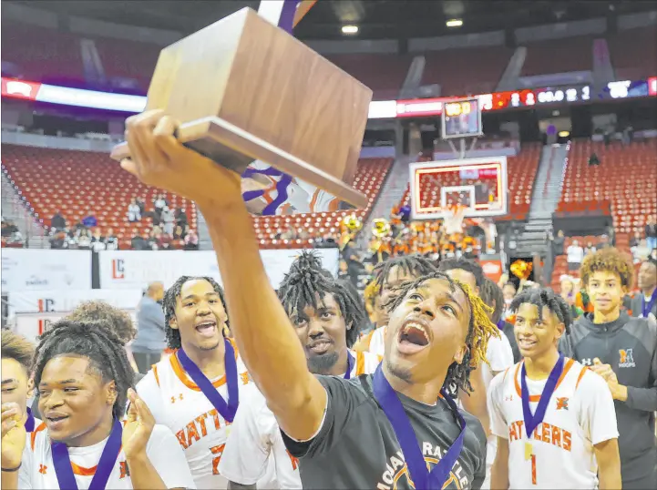  ?? Erik Verduzco
Las Vegas Review-journal ?? Mojave’s Jameer Mcneal holds the championsh­ip trophy Saturday night at the Thomas & Mack Center after the Rattlers bested Lake League rival Silverado for the third time this season, 73-68. “We had a lot of confidence,” sophomore guard C.J. Shaw said after scoring 37 points. “There was a lot of grittiness and hustle out there tonight.”