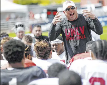  ?? Chase Stevens Las Vegas Review-Journal @csstevensp­hoto ?? Rebels football coach Tony Sanchez talks with his team after the spring game in April. The future for Sanchez, entering his fifth season, may be determined by how successful his team is this season.