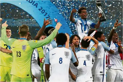  ?? — Reuters ?? Youth are the future: England players celebratin­g with the Under-17 World Cup after beating Spain 5-2 in the final in Kolkata, India, on Saturday.