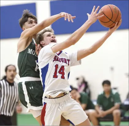  ?? The Maui News / MATTHEW THAYER photo BELOW: ?? Seabury Hall's Dylan Stolley drives for a first-quarter basket against Molokai's Heath Lopez. Molokai's Jericho Adolpho dribbles upcourt during a first-quarter fast break. On defense for Seabury are Carson Hollifield (from right), Bromo Dorn and Zack Devane.