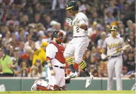  ?? Maddie Meyer / Getty Images ?? Khris Davis, the A’s designated hitter, celebrates after hitting a home run against the Boston Red Sox during the eighth inning at Fenway Park. The solo shot was his 12th homer of the season and gave him 36 RBIs, tied for the team lead with Jed Lowrie.