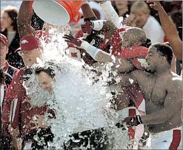  ?? Arkansas Democrat-Gazette/DAVID GOTTSCHALK ?? Houston Nutt is doused with a bucket of water in the closing minutes of the 2000 Cotton Bowl against Texas in Dallas. Nutt, in his second season as the Arkansas Razorbacks’ coach, led the Hogs to a 27-6 victory over the Longhorns.