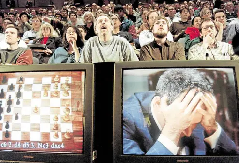  ?? —PHOTOS BY AFP ?? QUARTER CENTURY Chess enthusiast­s watched as World Chess champion Garry Kasparov held his head in his hands during the sixth and final match against IBM’s Deep Blue computer on May 11, 1997 in New York. Kasparov lost this match in just 19 moves giving overall victory to Deep Blue with a score of 2.5-3.5.