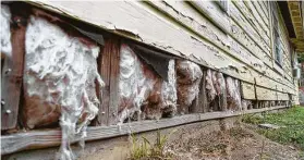  ?? Mark Mulligan / Staff photograph­er ?? Siding falls off Valeria Tamez’s southeast Houston home, shown Nov. 13, as her relief applicatio­n was moved from the city’s program to the General Land Office.