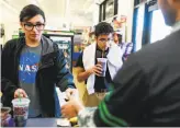  ?? Gabrielle Lurie / The Chronicle ?? Carlos Ramirez (left) and Josue Llamas buy Big Gulp sodas at a 7-Eleven in S.F. Legislator­s will consider banning such big sugary drinks.