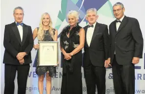  ??  ?? Kim Deane, an investment specialist at Coronation Fund Managers, holds the certificat­e for the Third-best South African Management Company of the Year. With her are, from left, Martin Hesse, the content editor of Personal Finance; Adri Senekal de Wet,...