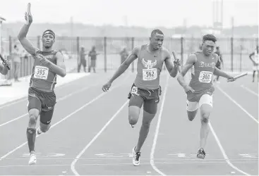  ?? Leslie Plaza Johnson photos ?? George Ranch’s Jayson Baldridge, left, crosses the finish line first to lead the Longhorns to victory in the 400-meter relay en route to winning the Class 6A Region III boys team title. Baldridge also anchored George Ranch’s winning 1,600 relay team and won the 300 hurdles in 36.07 seconds.