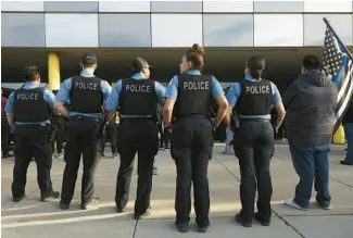  ?? JOHN J. KIM/CHICAGO TRIBUNE ?? Chicago police officers attend a vigil for Officer Aréanah Preston outside the 5th District station on May 9.