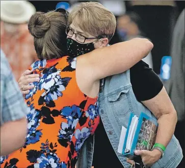  ?? Santiago Mejia Pool photo ?? MARY BERWERT, left, and Debbi Domingo McMullan embrace after the sentencing.“These rapes and these murders ... have cut across families, friends, generation­s and entire communitie­s,” said one district attorney.