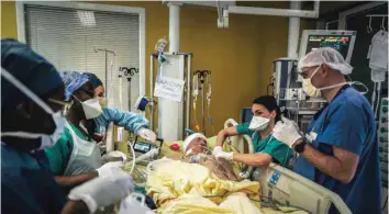  ?? — AFP ?? Medical staff members take care of a NON-COVID patient after a surgery interventi­on at the ICU of the Lariboisie­re Hospital in Paris.