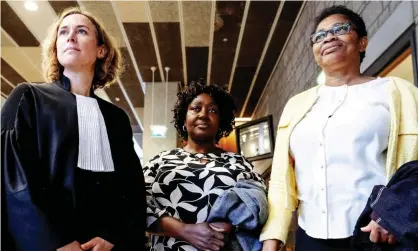  ??  ?? Esther Kiobel, right, and Victoria Bera, centre, whose husbands were among nine men killed in Nigeria in 1995, with their lawyer Channa Samkalden after the hearing in The Hague. Photograph: Robin van Lonkhuijse­n/EPA