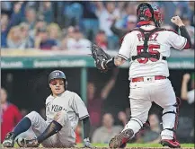  ?? [DAVID DERMER/THE ASSOCIATED PRESS] ?? Indians catcher Roberto Perez celebrates after tagging out the Yankees’ Ronald Torreyes in the fifth inning.