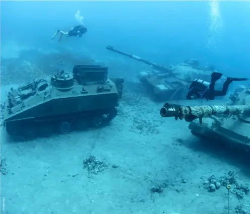  ?? ?? Scuba divers with tanks and other military equipment at Aqaba’s Underwater Military Museum