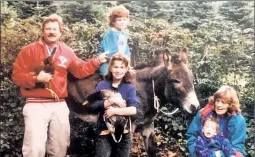  ??  ?? EVERGREEN ACRES: Post reporter Natalie O’Neill (middle, holding a duck) on her family’s Oregon tree farm in 1992. They sold noble firs, which now cost hundreds in Manhattan, for $5. But the chopping was DIY.