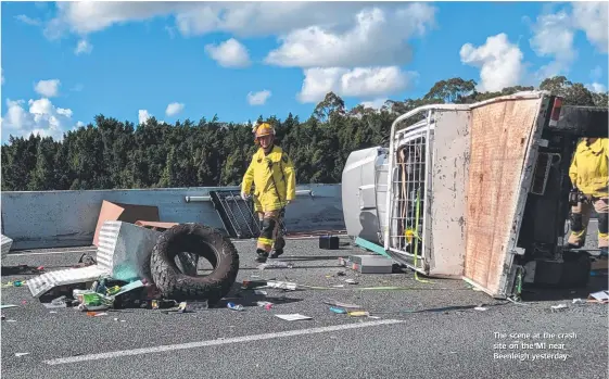  ??  ?? The scene at the crash site on the M1 near Beenleigh yesterday.