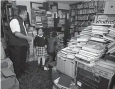  ?? FERNANDO VERGARA/THE ASSOCIATED PRESS ?? Jose Gutierrez talks to kids visiting his home library in Bogota.