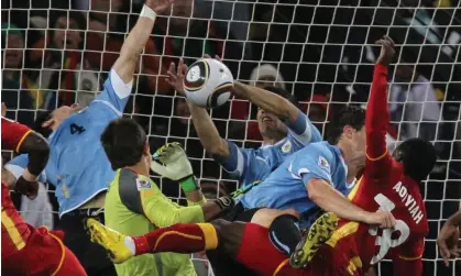  ?? Photograph: Yasuyoshi Chiba/AFP/Getty Images ?? Luis Suárez handles the ball in the dying seconds against Ghana in 2010, earning a red card before Asamoah Gyan missed the penalty.