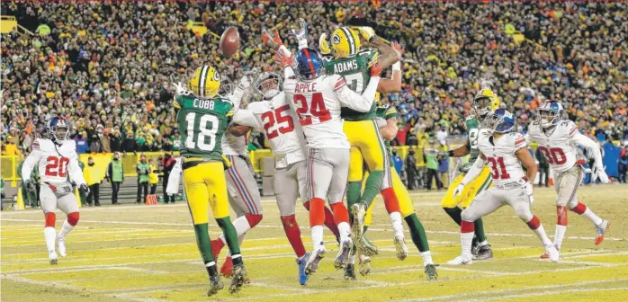  ?? | STACY REVERE/ GETTY IMAGES ?? Green Bay Packers wide receiver Randall Cobb leaps to catch Aaron Rodgers’ Hail Mary for a touchdown at the end of the second quarter Sunday against the New York Giants at Lambeau Field.