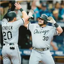  ?? CHRIS O’MEARA/AP ?? The White Sox’s Jake Burger, right, celebrates his two-run home run off Rays reliever Jalen Beeks with Danny Mendick during the eighth inning Saturday in St. Petersburg, Fla.