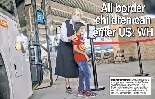  ??  ?? BIENVENIDO­S: A nun escorts a young asylum-seeker at the Texas border town of Brownsvill­e. The Biden administra­tion says it will allow all unaccompan­ied minors into the US, reversing a Trump policy.