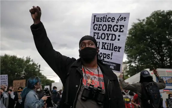  ?? NAncy lAnE pHoToS / HErAld STAFF FIlE ?? TAKING A STAND: Jay E marches against police violence from City Hall to the Ruggles T station near police headquarte­rs on Sunday.