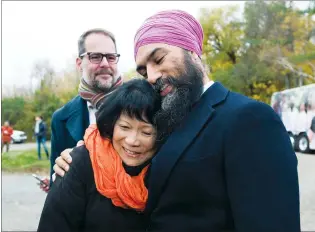  ?? CP PHOTO NATHAN DENETTE ?? NDP leader Jagmeet Singh hugs Olivia Chow, widow of former NDP leader Jack Layton, as they make an announceme­nt at Jack Layton Park during a campaign stop in Hudson, Que., on Wednesday.