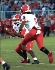  ?? File-LARRY GREESON / For the Calhoun Times ?? Sonoravill­e’s Patrick Moore (left) prepares to make the handoff to Trenton Daniel during last Friday’s game against LFO.