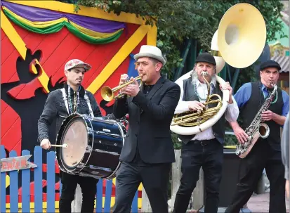  ?? PHOTOS BY CHRIS RILEY — TIMES-HERALD ?? Members of the Honor Brass Band play music if New Orleans flair as they walk around Six Flags Discovery Kingdom to kickoff the Mardi Gras festival on Saturday in Vallejo.