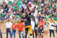  ?? PAUL SANCYA/ASSOCIATED PRESS ?? Notre Dame’s Jalen Elliott, left, breaks up a pass intended for New Mexico tight end Marcus Williams. The seventhran­ked Irish beat the Lobos 66-14.