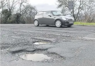  ?? ?? Our pothole-strewn roads are the result of long-term neglect, says Tom Wood