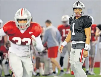  ?? [KYLE ROBERTSON/DISPATCH] ?? Quarterbac­k Justin Fields took most of the first-team reps during Ohio State’s practice at the Woody Hayes Athletic Center on Saturday.