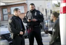  ?? THE ASSOCIATED PRESS ?? In this Tuesday photo, police officers Jimmy Priore, left, and Manny Sharma talk with a driver who was pulled over for an invalid registrati­on in the Brooklyn borough of New York. Even after two terrorist attacks and a motorist’s deadly rampage through...