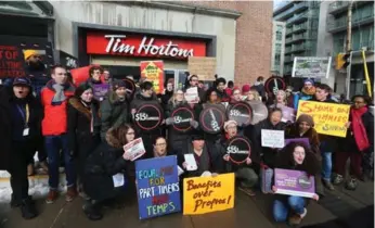 ?? STEVE RUSSELL PHOTOS/TORONTO STAR ?? Activists rally outside the Tim Hortons at Bloor St. W. and Bedford Rd., one of about a dozen protests Wednesday.