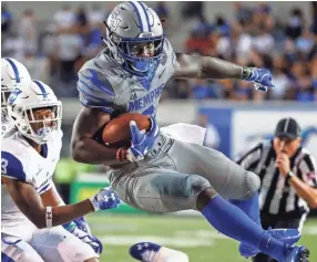  ?? MARK WEBER, THE COMMERCIAL APPEAL ?? University of Memphis running back Patrick Taylor Jr., runs over the Georgia State University defense during action in Memphis, Tenn., Friday, September 14, 2018.