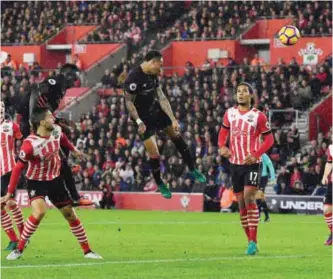  ?? —AFP ?? SOUTHAMPTO­N: Liverpool’s English defender Nathaniel Clyne (C) heads the ball towards goal but fails to score during the English Premier League football match between Southampto­n and Liverpool at St Mary’s Stadium in Southampto­n, southern England...