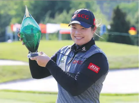  ?? VAUGHN RIDLEY/GETTY IMAGES ?? Ariya Jutanugarn smiles while holding the trophy after sinking a birdie putt on the first playoff hole to win the Manulife LPGA Classic at Whistle Bear Golf Club on Sunday in Cambridge, Ont. The three-way playoff included Lexi Thompson and In Gee Chun.