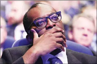  ?? ?? Britain’s Chancellor of the Exchequer Kwasi Kwarteng listens to Britain’s Prime Minister Liz Truss making a speech at the Conservati­ve Party conference at the ICC in Birmingham, England, on Oct 5, 2022. (AP)