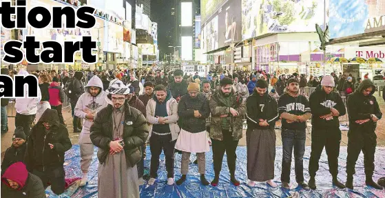 ?? AP ?? Members of the Muslim community gather for the Taraweeh prayer during a month of Ramadan in New York’s Times Square on Sunday.
