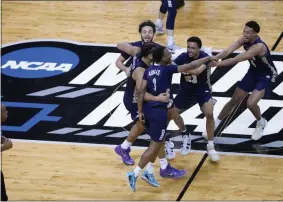  ?? AJ MAST - THE ASSOCIATED PRESS ?? Oral Roberts players celebrate at the end of a college basketball game against Florida in the second round of the NCAA tournament at Indiana Farmers Coliseum, Sunday, March 21, 2021 in Indianapol­is. Oral Roberts won 81-78.