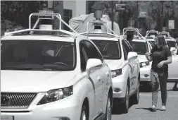  ??  ?? AP FILE PHOTO BY ERIC RISBERG This May 13, 2014 photo shows a row of Google self-driving Lexus cars at a Google event outside the Computer History Museum in Mountain View.