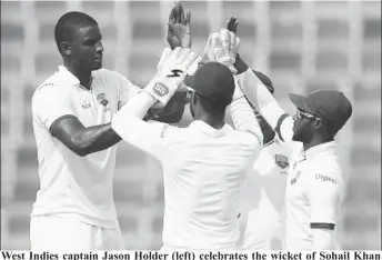  ??  ?? West Indies captain Jason Holder (left) celebrates the wicket of Sohail Khan during his three-wicket haul on the second day of the second Test against Pakistan.