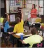  ?? THE ASSOCIATED PRESS ?? Shelly Ellis teaches fourthgrad­e students at Bement Elementary School in Bement, Ill.
