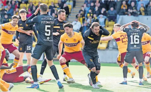  ?? ?? Anguish Livingston players are distraught while Ricki Lamie celebrates his goal