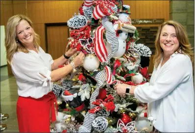  ?? (Arkansas Democrat-Gazette/Cary Jenkins) ?? Leslie Smith and Sonia Worsham began the planning of decorating trees for the Festival of Trees in January, when they went to market in Dallas. There they saw the latest trends in holiday decor and bought ornaments, ribbon and other decoration­s.