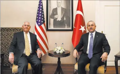  ??  ?? The Associated Press Backdroppe­d by a picture of modern Turkey’s founder, Mustafa Kemal Ataturk, Turkey’s Foreign Minister Mevlut Cavusoglu meets Friday with Secretary of State Rex Tillerson in Ankara, Turkey.