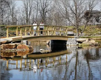  ?? LISA POWELL / STAFF ?? A stroll through Cox Arboretum MetroPark has become more accessible for visitors to the site. The scenic “Monet Bridge” has been upgraded and is now ADA accessible. A new brick-paved path also loops through the park, making it easier for strollers and...