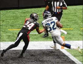  ?? CURTIS COMPTON / CURTIS.COMPTON@AJC.COM ?? Seahawks running back Chris Carson gets into the end zone past Falcons rookie cornerback A.J. Terrell to give Seattle a 7-3 lead during the first quarter Sunday. Ricardo Allen’s pass interferen­ce penalty helped set it up.