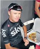  ??  ?? To top it off: Chris Froome settled down to enjoy a post-race pizza