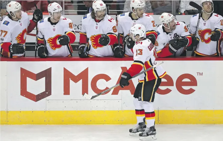  ?? — GETTY IMAGES ?? Johnny Gaudreau of the Calgary Flames celebrates with teammates after scoring in Monday’s 4-1 win over the Washington Capitals.